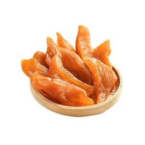 May include: A pile of orange, translucent dried sweet potato slices arranged in a small, round, light-colored woven bamboo basket. The pieces have a fibrous, chewy texture and a glossy surface, stacked together to form a mound of food.