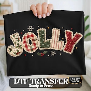 May include: A black fabric item featuring the word JOLLY in large, decorative letters. Each letter has a unique pattern: holly leaves, red and green plaid, green with white dots, red and white stripes, and a quilted red texture with gold stars.