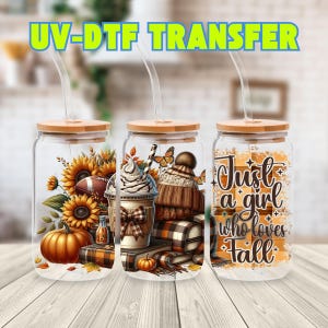 May include: Three clear glass tumblers with bamboo lids and clear straws. The first features sunflowers, a pumpkin, and a football. The second shows a coffee cup, a knit hat, and a plaid blanket. The third displays the text Just a girl who loves Fall.
