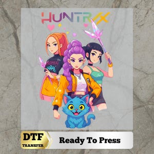 May include: A DTF transfer sheet featuring the text HUNTRX at the top and Ready To Press at the bottom. The central graphic depicts three anime-style characters with colorful hair and outfits, holding crystal wands, accompanied by a bright blue cat.