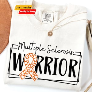 May include: Cream-colored t-shirt with the words "Multiple Sclerosis Warrior" in black, featuring an orange ribbon with heart-shaped cutouts. The shirt has a round neckline and a gold necklace with a pendant. The words "DTF Transfer Ready To Press" are in the upper left corner.