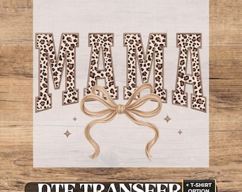 May include: A DTF transfer sheet featuring the word MAMA in block letters with a brown and tan leopard print pattern. Below the text is a large, light brown ribbon bow illustration with four small star accents on a white background.