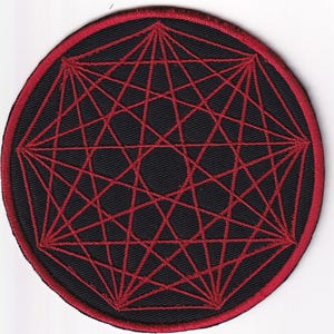 May include: A circular embroidered patch featuring a black fabric base with a red stitched border. The center displays a complex geometric pattern of intersecting red lines forming a nonagram star shape against the solid black background.