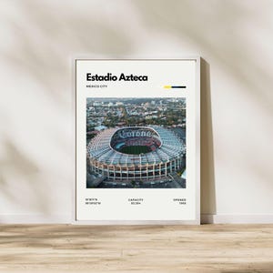 May include: A framed print featuring an aerial view of Estadio Azteca in Mexico City. The stadium is a large, circular structure with a distinctive roof. The print includes the stadium's name, location, and opening year.