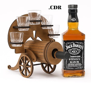 May include: A wooden shot glass and whiskey display in the shape of a cannon. The display holds six shot glasses and is next to a bottle of Jack Daniel's Tennessee Whiskey. The display is made of brown wood.