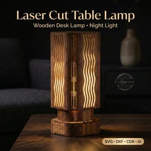May include: A laser-cut wooden table lamp with a warm glow. The lamp features a cylindrical design with wavy cutouts, creating a unique light pattern. The text on the image reads "Laser Cut Table Lamp" and "Wooden Desk Lamp • Night Light."
