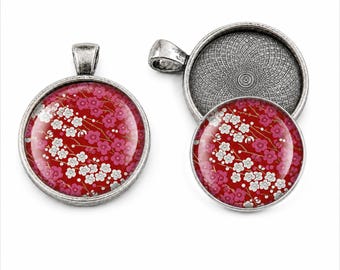 May include: Two round pendants with an antique silver finish. One pendant is fully assembled with a red background featuring a pattern of white and pink cherry blossoms. The second pendant is shown as an empty metal tray with a textured interior.