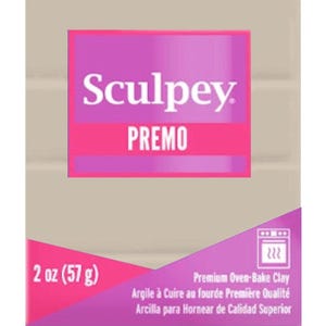 May include: A package of Sculpey Premo polymer clay. The package is primarily purple and pink, with the brand name and product line prominently displayed. It contains 2 oz (57 g) of premium oven-bake clay, with text in English, French, and Spanish.