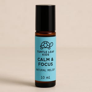 May include: A brown glass roll-on bottle with a black cap and a light blue label. The label features a turtle logo and the words "CALM & FOCUS" and "NATURAL RELIEF". The bottle contains 10 ml of product.