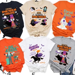 May include: A collection of five short-sleeve t-shirts featuring Halloween-themed graphics. Designs include a vampire mouse, a headless horseman, and various spooky characters with text such as Virtual Spooktacular Challenge 26, Eternal Waltz, and Dig & Dash.