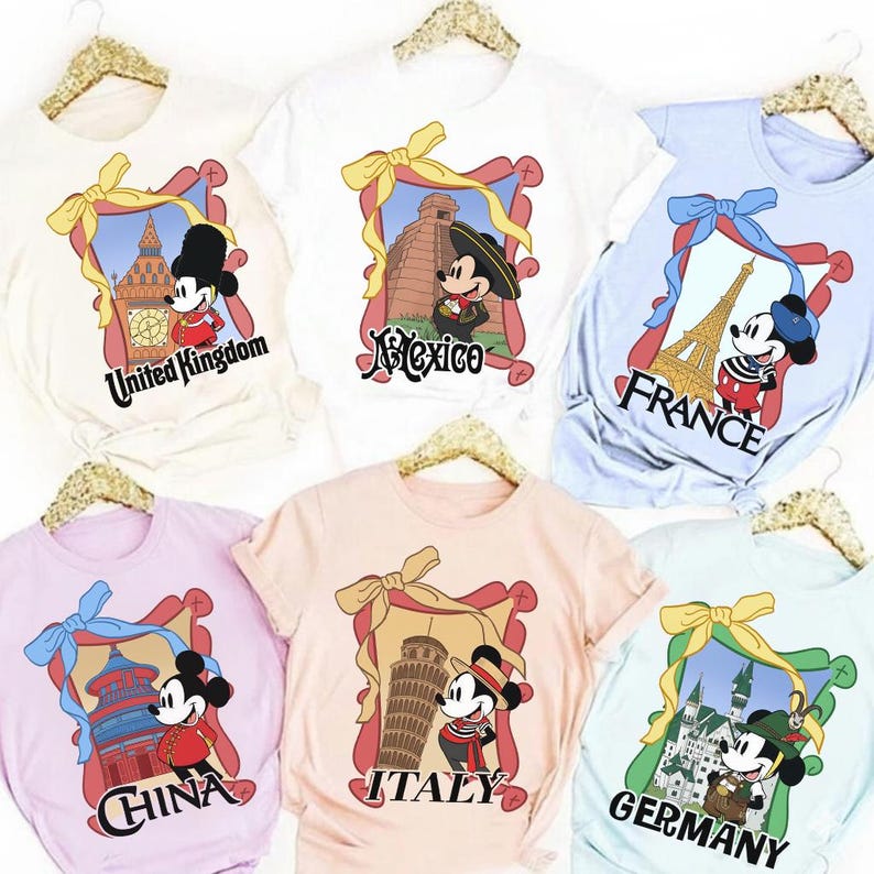 May include: A collection of t-shirts featuring Mickey Mouse in various travel-themed designs. Each shirt showcases a different country, including the United Kingdom, Mexico, France, China, Italy, and Germany, with corresponding landmarks and text.