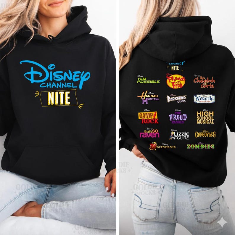 May include: Black hooded sweatshirt featuring the Disney Channel logo in blue and the word "NITE" in yellow. The back displays logos from various Disney Channel shows, including "Kim Possible" and "High School Musical."