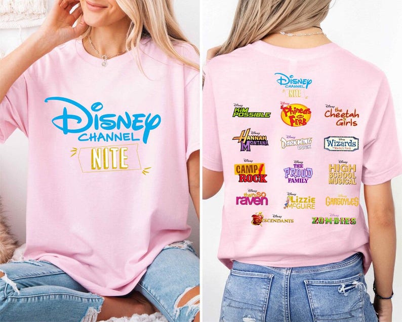 May include: Pink t-shirt featuring the Disney Channel logo in blue, with "NITE" in a yellow banner. The back of the shirt displays logos from various Disney Channel shows, including "Kim Possible," "Phineas and Ferb," and "The Cheetah Girls."