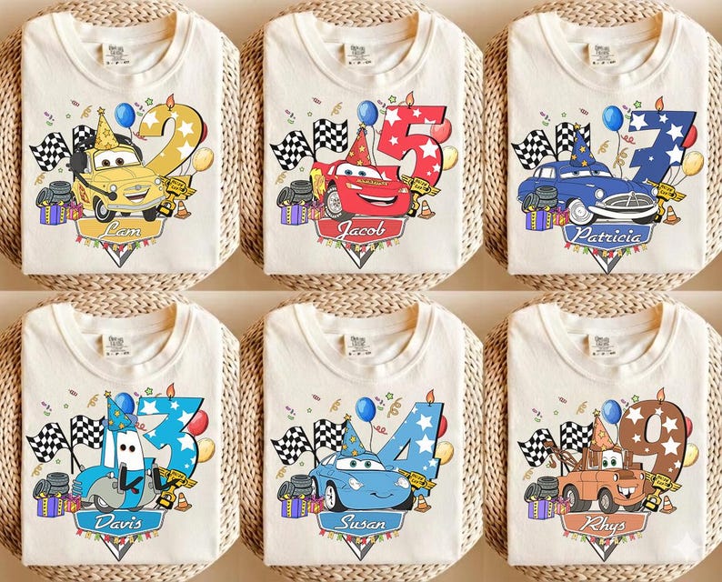 May include: Cream-colored t-shirts featuring colorful cartoon car designs with numbers and names. Each shirt has a different car character, number, and name, with racing flags and party decorations. Perfect for a birthday celebration.