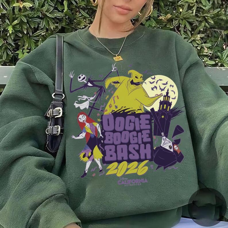 May include: Dark green sweatshirt featuring a graphic design with characters from The Nightmare Before Christmas. The design includes Jack Skellington, Sally, Oogie Boogie, and the text "Boogie Boogie Bash 2026".