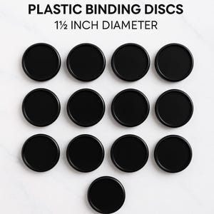 May include: A collection of black plastic binding discs, each with a 1.5-inch diameter, arranged on a white surface. The discs are circular and have a smooth, matte finish. The text "PLASTIC BINDING DISCS" and "1 1/2 INCH DIAMETER" is displayed at the top.