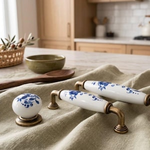 May include: A set of three ceramic mugs with a speckled, matte finish. The mugs are in shades of cream, light gray, and dark gray. Each mug has a simple, minimalist design, perfect for coffee or tea.