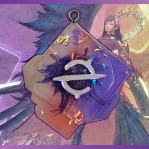 May include: A geometric pendant with a silver-colored loop at the top. The pendant features a design with a white and silver symbol over a dark blue and orange background. The background has a feather-like design. The pendant is set against a purple background.