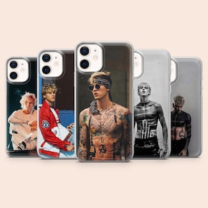 May include: A set of five clear phone cases, each displaying a different image of a person. The images are diverse, including both colour and monochrome portraits. The cases are designed to fit a smartphone.