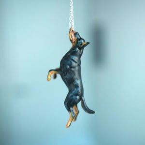Car hanging ornament – dog Beauceron catching a tug toy