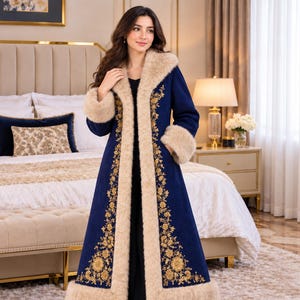 May include: A long, deep blue coat featuring a thick, beige faux fur trim along the collar, front opening, cuffs, and hem. The coat is decorated with intricate gold floral embroidery running vertically along the front panels.