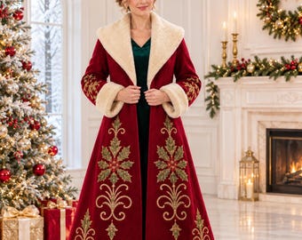 May include: A floor-length deep red coat featuring a wide cream-colored faux fur collar and cuffs. The coat is decorated with intricate gold and green embroidered holly leaf patterns along the front panels and sleeves, worn over a dark green dress.