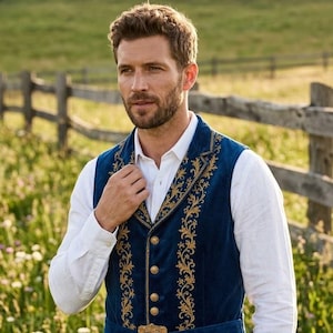 May include: A deep blue velvet vest featuring intricate gold embroidery along the lapels and front panels. The garment includes a matching blue velvet belt with a decorative gold buckle at the waist and four round gold buttons down the center.