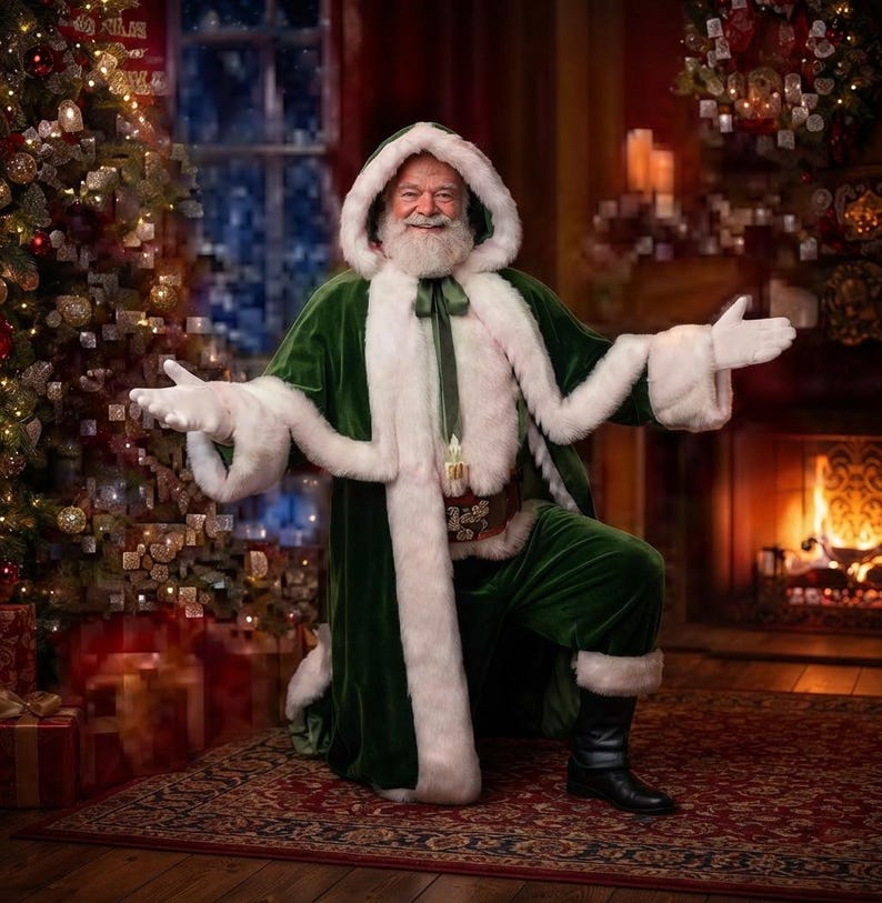 May include: A person dressed as Santa Claus wearing a long, deep green velvet hooded robe with thick white faux fur trim, a brown leather belt with gold accents, and black boots, with arms outstretched in a welcoming gesture.