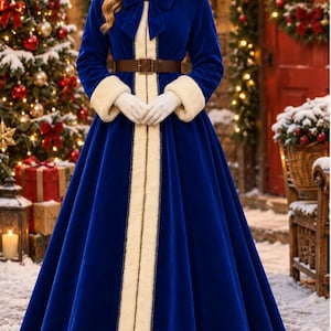 May include: A floor-length royal blue velvet coat featuring a hood with cream-colored faux fur trim, long sleeves with matching cuffs, a front bow closure, and a brown leather belt with a rectangular buckle at the waist.