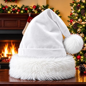 May include: A solid white Santa hat featuring a plush, thick faux fur trim around the base and a matching fluffy white pom-pom at the tip. The hat is constructed from a smooth, soft-textured fabric and maintains a classic pointed shape.