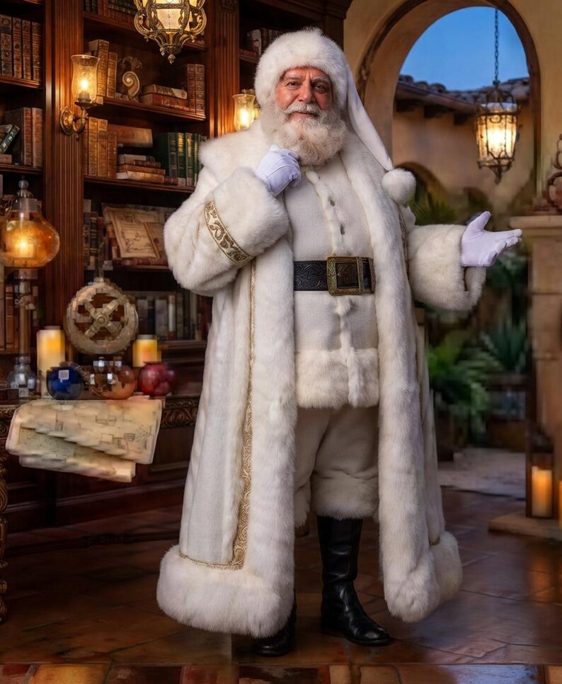 May include: A person dressed in a long, white faux fur coat with gold trim, matching white trousers, and a white fur hat. The outfit includes a black leather belt with a gold buckle and white gloves. The person has a full white beard and mustache.