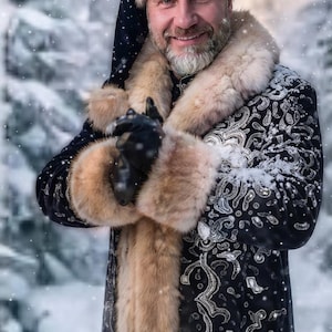 May include: A black coat with silver embroidery and tan fur trim, paired with a matching fur-trimmed hat. The coat features a long, thick tan fur collar and cuffs. The fabric is adorned with intricate silver patterns throughout the garment.
