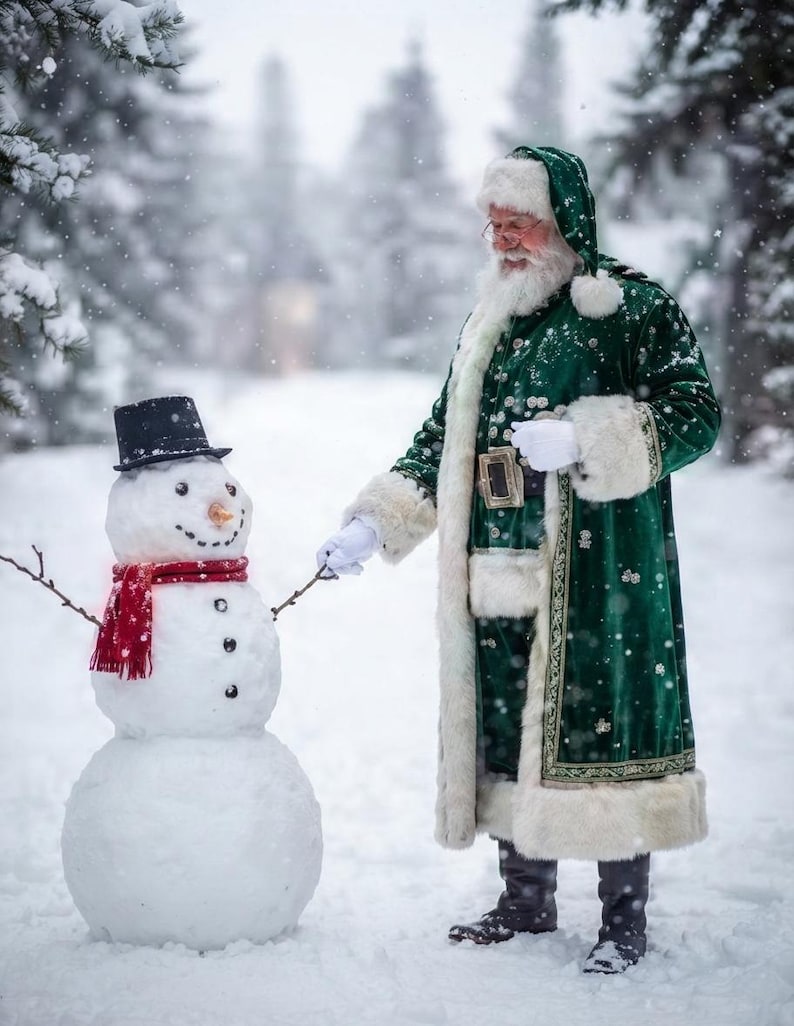 May include: A figure dressed in a long, dark green velvet coat with white fur trim, a matching hood, and white gloves, standing in the snow next to a snowman. The snowman wears a black top hat, a red scarf, and has a carrot nose and twig arms.