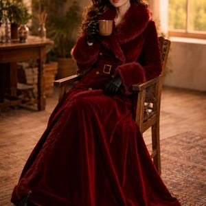 May include: A floor-length deep red velvet coat featuring a wide faux fur collar and matching faux fur cuffs. The coat includes a belted waist with a gold-toned buckle, double-breasted gold buttons, and a full-length skirt. Black leather gloves.