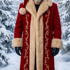 May include: A long red velvet coat with beige faux fur trim on the collar, cuffs, and hem, featuring gold embroidered scrollwork along the front. The coat is paired with a matching red velvet hat with a beige faux fur band and black gloves.