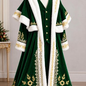 May include: A deep green velvet coat featuring a white faux fur trim, gold embroidery, and a matching hat. The coat includes a capelet overlay, a button-up vest underneath, and long sleeves with fur cuffs, all decorated with intricate gold floral patterns.