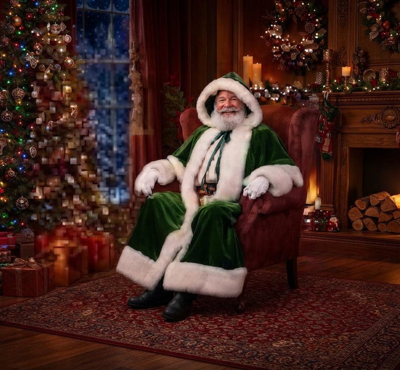May include: A person dressed as Santa Claus wearing a long, deep green velvet robe with thick white faux fur trim and a matching hood. The outfit includes white gloves and a dark green ribbon tie at the neck, seated in a plush burgundy armchair.