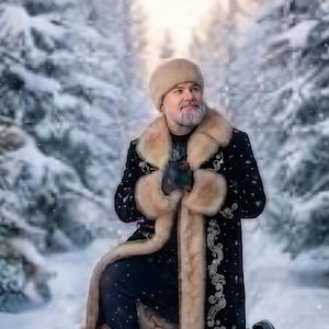 May include: A black long coat featuring light tan fur trim on the collar, cuffs, and hem, adorned with intricate silver embroidery. The garment is paired with a matching tan fur hat, creating a cohesive look for cold weather conditions.