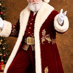 May include: A deep red velvet Santa Claus coat featuring thick white faux fur trim on the collar and cuffs, gold embroidered holly leaf patterns, a matching red velvet hat with a white pom-pom, and a wide gold metallic belt with a decorative buckle.