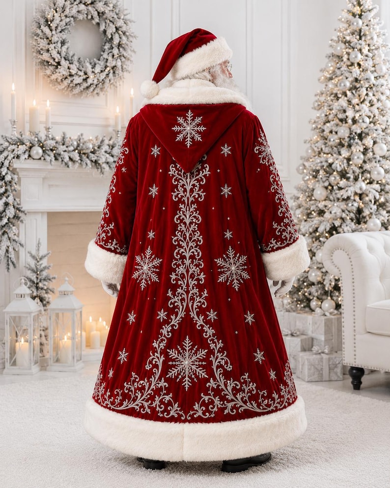 May include: A floor-length deep red velvet coat with a hood, featuring white faux fur trim on the cuffs, hem, and hood edge. The coat is decorated with intricate silver embroidery in swirling patterns and snowflake motifs throughout.