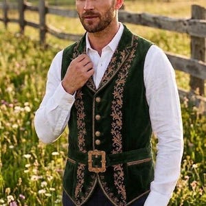 May include: A dark green velvet vest featuring intricate gold-toned floral embroidery along the lapels and front panels. The garment includes a central row of metallic buttons and a matching green waist belt secured with a large, ornate gold buckle.