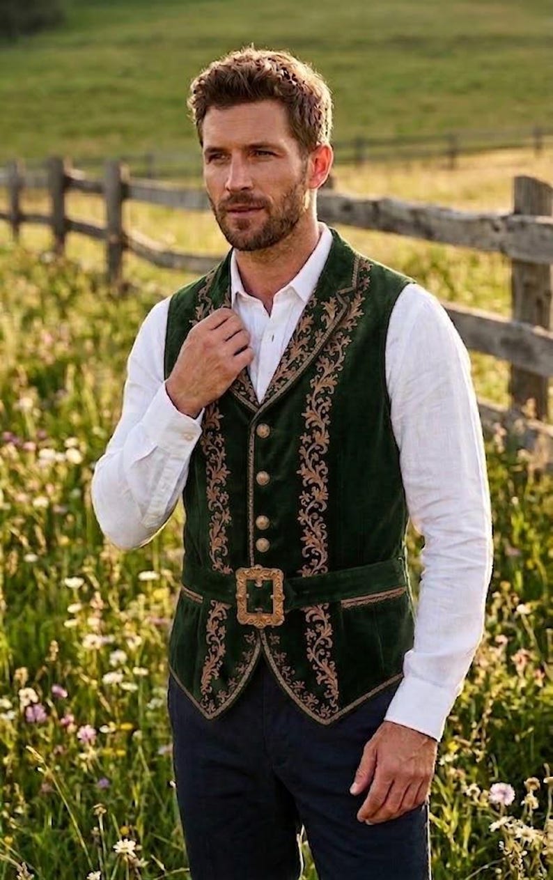 May include: A dark green velvet vest featuring intricate gold-toned floral embroidery along the lapels and front panels. The garment includes a central row of metallic buttons and a matching green waist belt secured with a large, ornate gold buckle.