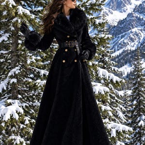May include: A long black coat featuring a wide faux fur collar and matching faux fur cuffs on the sleeves. The coat includes a double-breasted button front closure, a wide black belt with a rectangular buckle at the waist, and a full-length skirt.