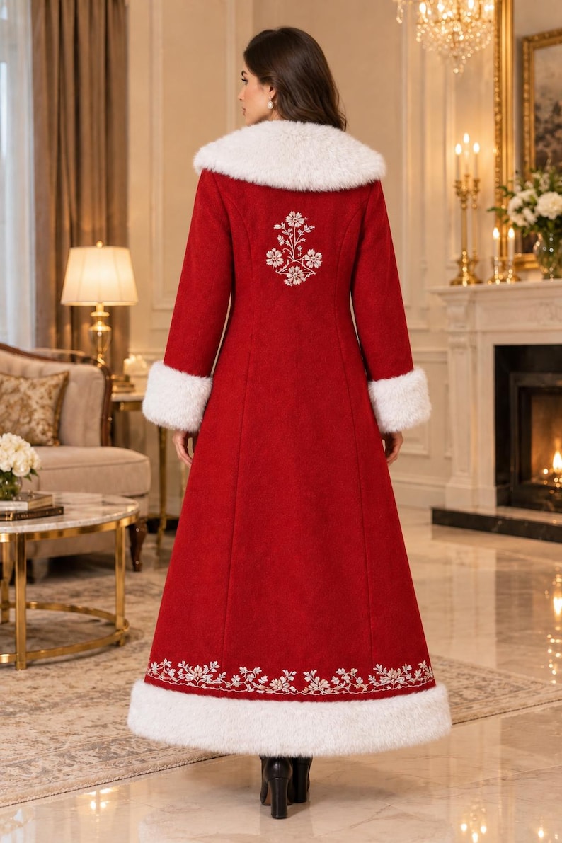 May include: A floor-length red coat featuring a white faux fur collar and cuffs. The back of the coat is decorated with white floral embroidery between the shoulders and a matching white floral border along the bottom hem above the fur trim.