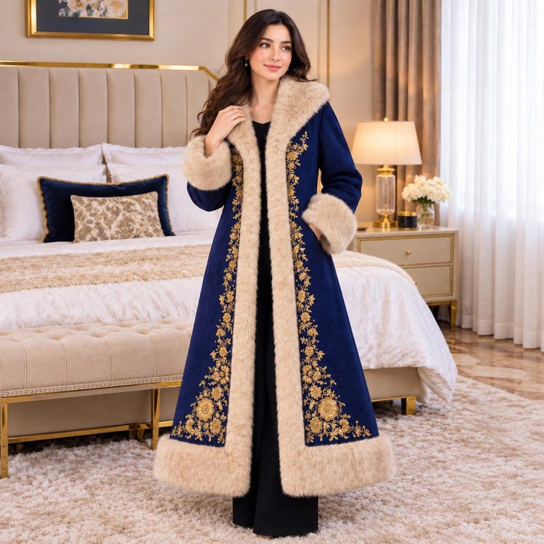 May include: A long, deep blue coat featuring a thick, beige faux fur trim along the collar, front opening, cuffs, and hem. The coat is decorated with intricate gold floral embroidery running vertically along the front panels.