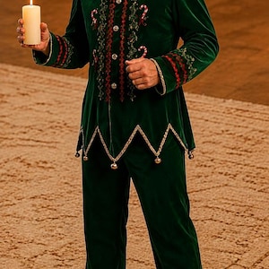 May include: A dark green velvet elf costume featuring a pointed hat with a white pom-pom, a jacket with gold trim, candy cane embroidery, and small bells along the hem, paired with matching trousers and a white pillar candle held in one hand.
