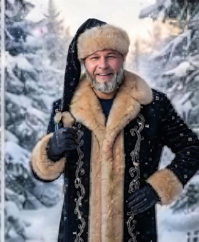 May include: A black coat with tan fur trim on the collar and cuffs, featuring silver embroidery. The coat is worn with a matching black fur hat and black leather gloves. The garment has a long, pointed black hat extension hanging down.