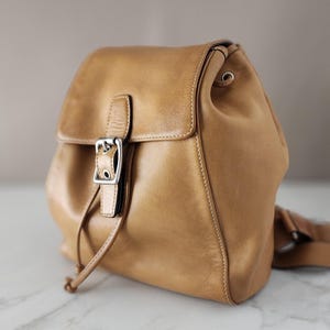 coach backpack tan Court In Signature Canvas Tan/Brown CZ176 Signature coated canvas Inside zip cell phone and multifunction pockets Laptop compartment with zip closure Zip closure recycled polyester lining Top handle with 2 drop Outside zip pockets Adjustable shoulder straps Fits a 12 (zip compartment) or 13 (main compartment) laptop 10 3/4 (L) x 14 (H) x 5 1/4 (W) Style No. Vintage COACH ~ Backpack Style