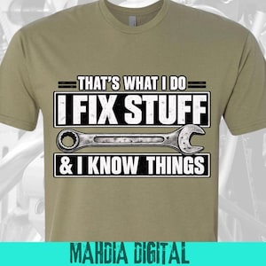 May include: A khaki-colored short-sleeve t-shirt featuring a graphic print with the text THAT'S WHAT I DO, I FIX STUFF, and & I KNOW THINGS in white block letters, centered around a detailed illustration of a silver metal combination wrench.