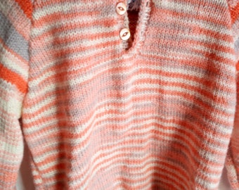 Childs varigated hoodie sweater in 100% pure wool orange, apricot, fawn and cream varigated yarn, with stripes on sleeves.